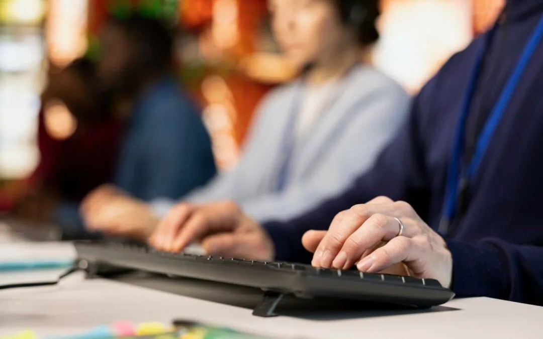 Two support staff working at keyboards, taking calls